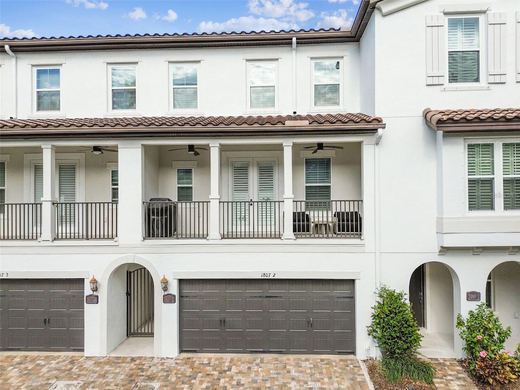 view of front of property with a garage and ceiling fan