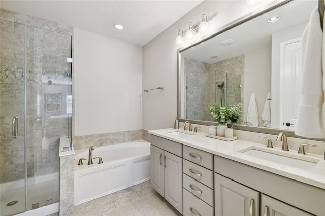 bathroom with vanity, a textured ceiling, and plus walk in shower