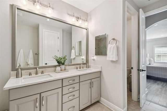 bathroom featuring vanity, toilet, and crown molding