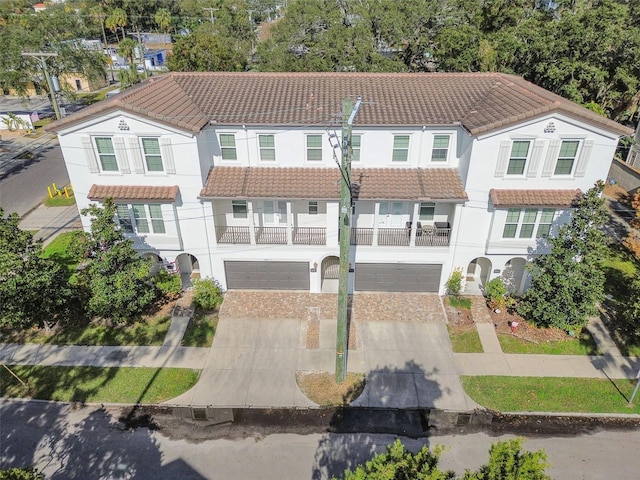 view of front of home with a balcony and a garage