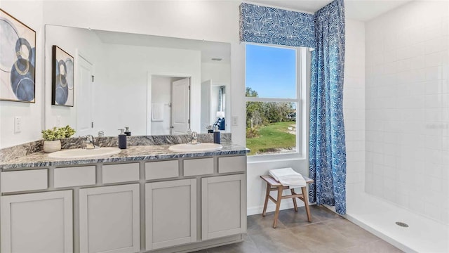 bathroom with tile patterned flooring, vanity, and curtained shower