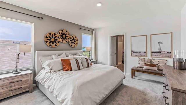 carpeted bedroom featuring connected bathroom and multiple windows