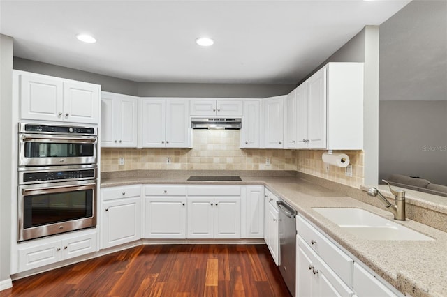 kitchen with white cabinetry, sink, stainless steel appliances, and dark hardwood / wood-style floors