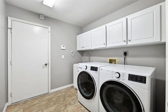 laundry room with cabinets and washer and clothes dryer