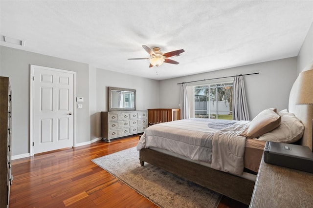 bedroom featuring ceiling fan, wood-type flooring, and a textured ceiling