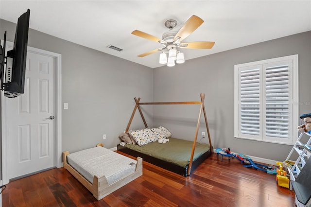 bedroom with ceiling fan and dark hardwood / wood-style flooring