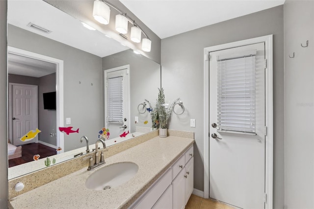 bathroom with tile patterned floors and vanity