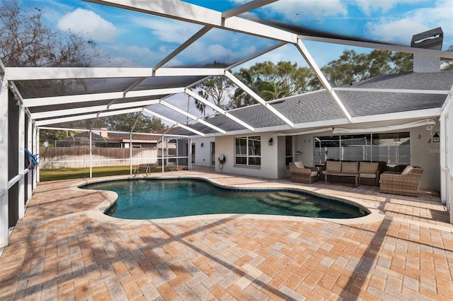 view of pool featuring a patio, an outdoor hangout area, glass enclosure, and ceiling fan