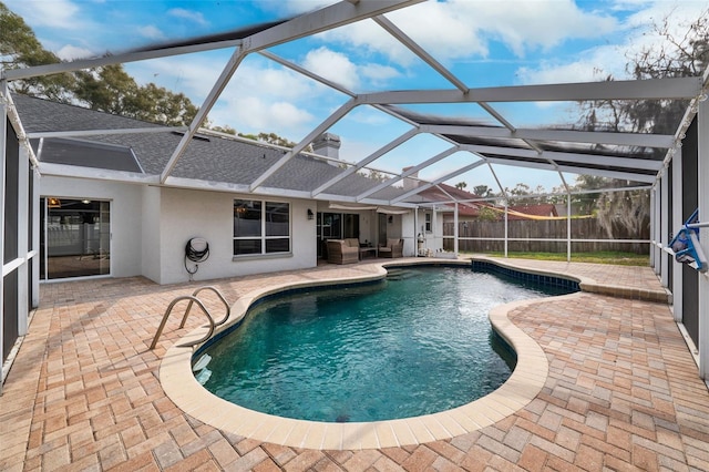 view of swimming pool with a lanai and a patio area