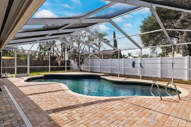 view of pool with a patio and glass enclosure