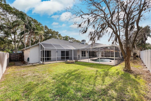 rear view of house featuring a patio, a fenced in pool, glass enclosure, and a lawn