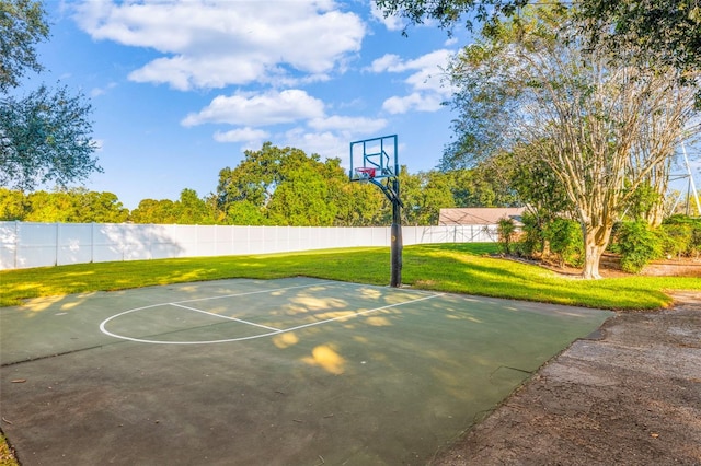 view of sport court with a yard