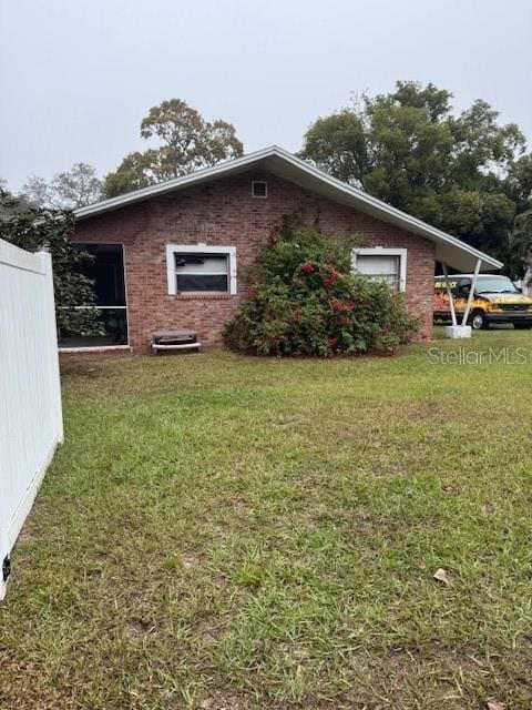 view of property exterior featuring a lawn