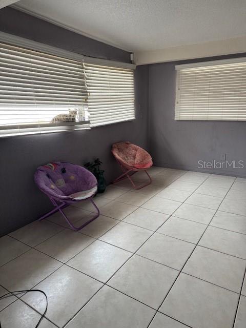 sitting room with light tile patterned floors and a textured ceiling