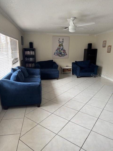 living room featuring ceiling fan, light tile patterned flooring, crown molding, and a textured ceiling