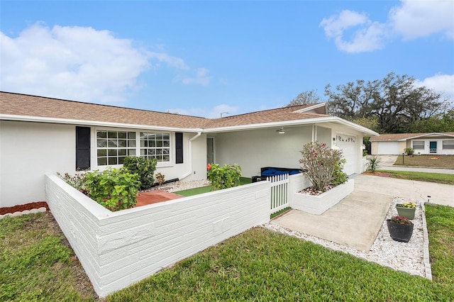 ranch-style house featuring a front yard and a garage