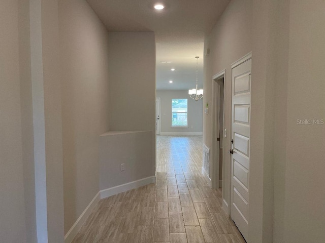 corridor with a chandelier