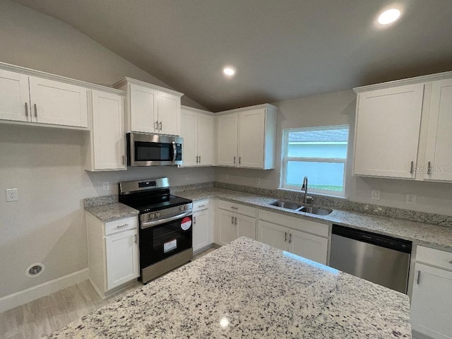 kitchen with white cabinetry, sink, lofted ceiling, and appliances with stainless steel finishes