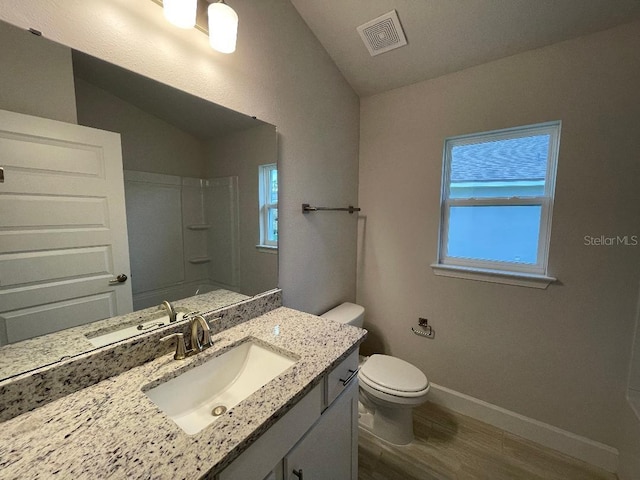 full bathroom featuring shower / bath combination, wood-type flooring, vaulted ceiling, toilet, and vanity