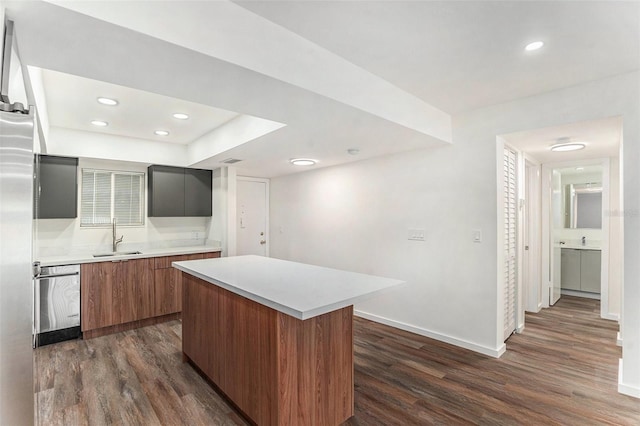 kitchen with dishwasher, a center island, sink, and dark hardwood / wood-style flooring