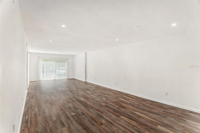 unfurnished room with dark hardwood / wood-style floors