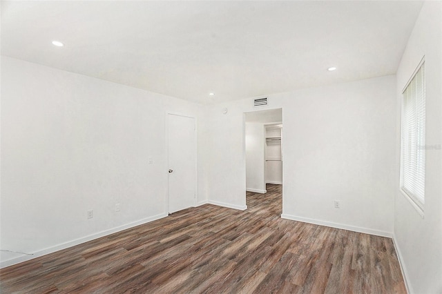 unfurnished room featuring dark hardwood / wood-style flooring