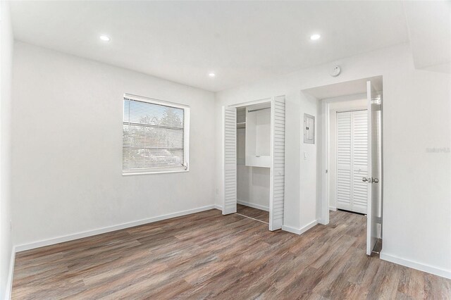 unfurnished bedroom with hardwood / wood-style flooring and a closet