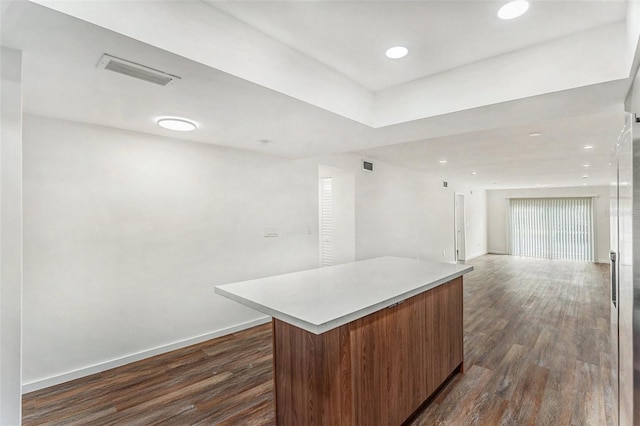 kitchen with dark hardwood / wood-style floors and a center island