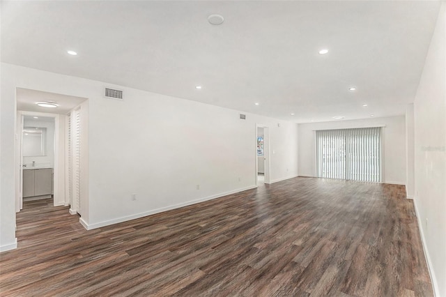 unfurnished living room with dark wood-type flooring