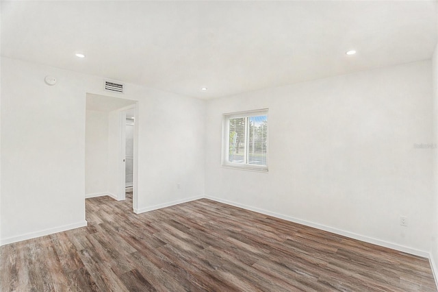 unfurnished room featuring dark wood-type flooring