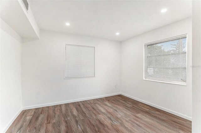 unfurnished room with dark hardwood / wood-style floors