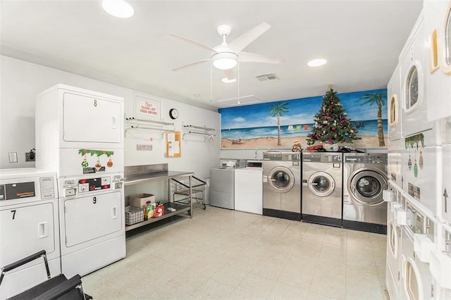 laundry room with stacked washer / dryer, washer and dryer, and ceiling fan