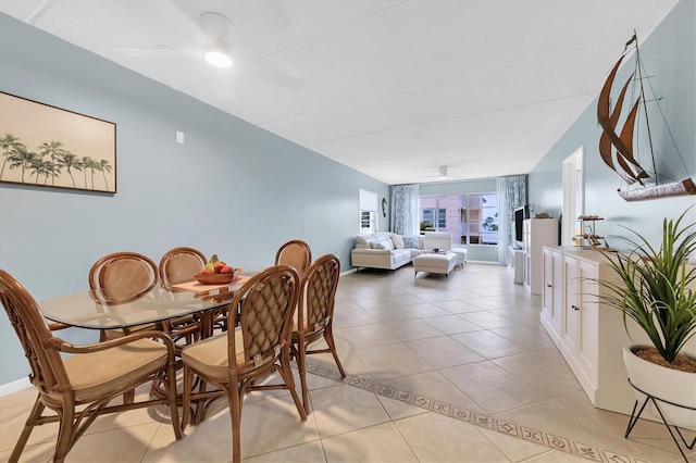 tiled dining area with ceiling fan