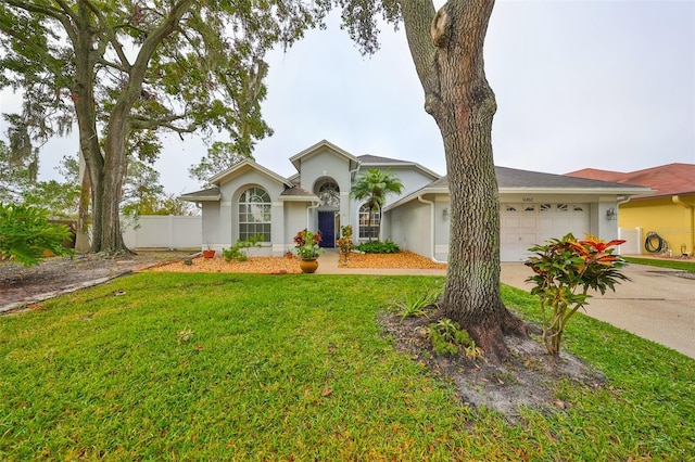 ranch-style home with a front yard and a garage