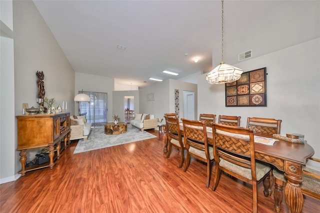 dining space with hardwood / wood-style flooring