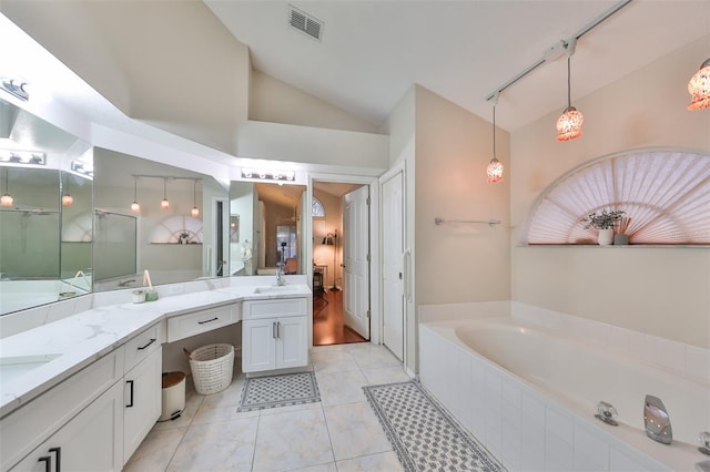 bathroom featuring shower with separate bathtub, vanity, and lofted ceiling