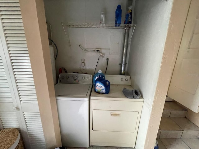 clothes washing area featuring independent washer and dryer and light tile patterned floors