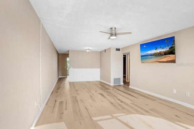 spare room featuring light wood-type flooring and ceiling fan