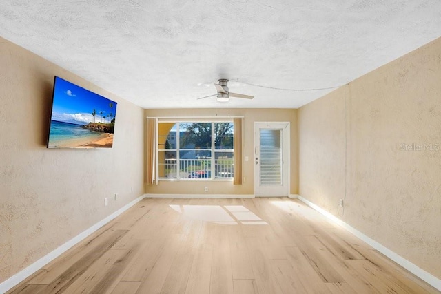 spare room featuring a textured ceiling, light hardwood / wood-style floors, and ceiling fan