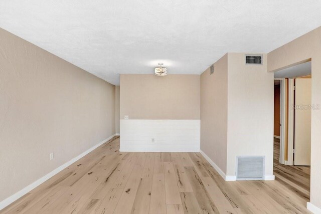 unfurnished room featuring light hardwood / wood-style flooring