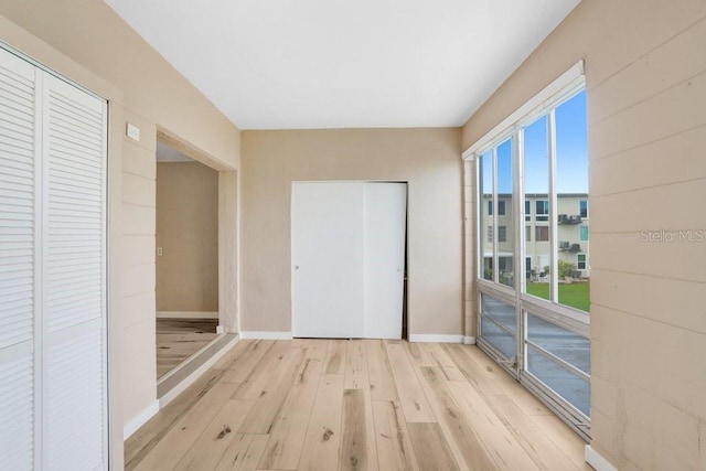 unfurnished bedroom with a closet and light wood-type flooring