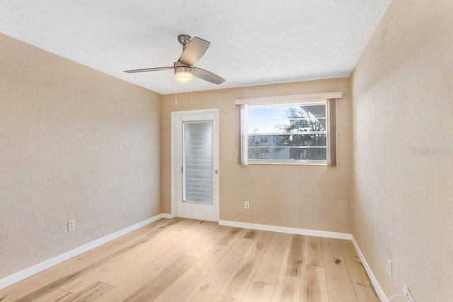 empty room with light hardwood / wood-style floors and ceiling fan