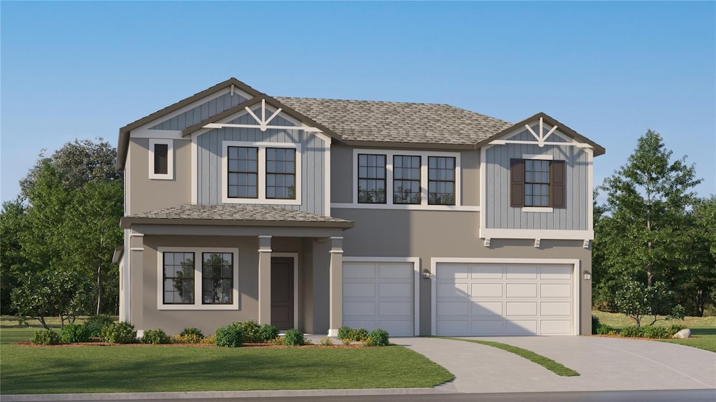 view of front of house featuring a garage and a front lawn