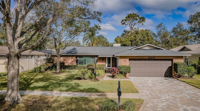 single story home with a garage and a front yard