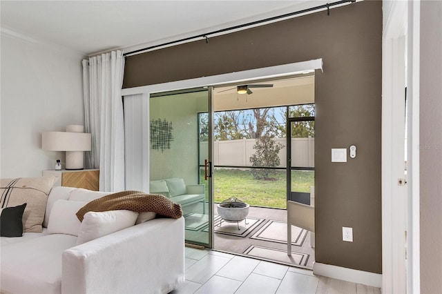 doorway to outside featuring ceiling fan and light tile patterned floors