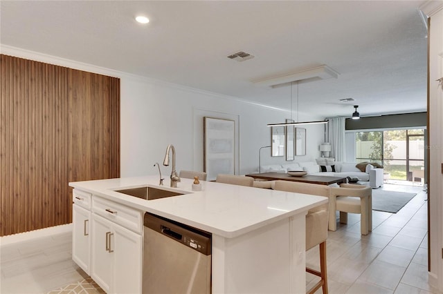 kitchen with a center island with sink, sink, stainless steel dishwasher, ceiling fan, and white cabinetry