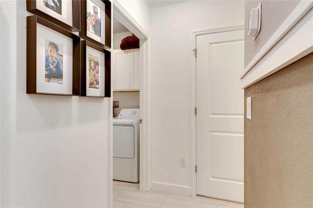 laundry area featuring cabinets, light tile patterned flooring, and washer / dryer