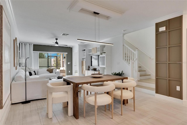 dining area featuring ceiling fan and ornamental molding