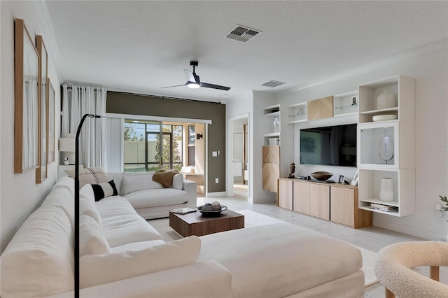 living room featuring ceiling fan, built in features, and a textured ceiling