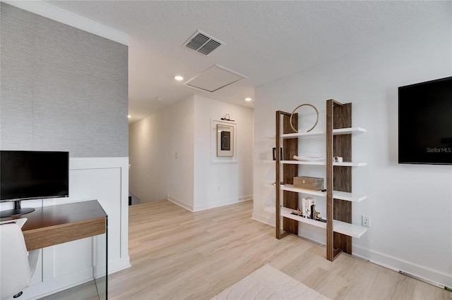 living room featuring light hardwood / wood-style flooring and a textured ceiling